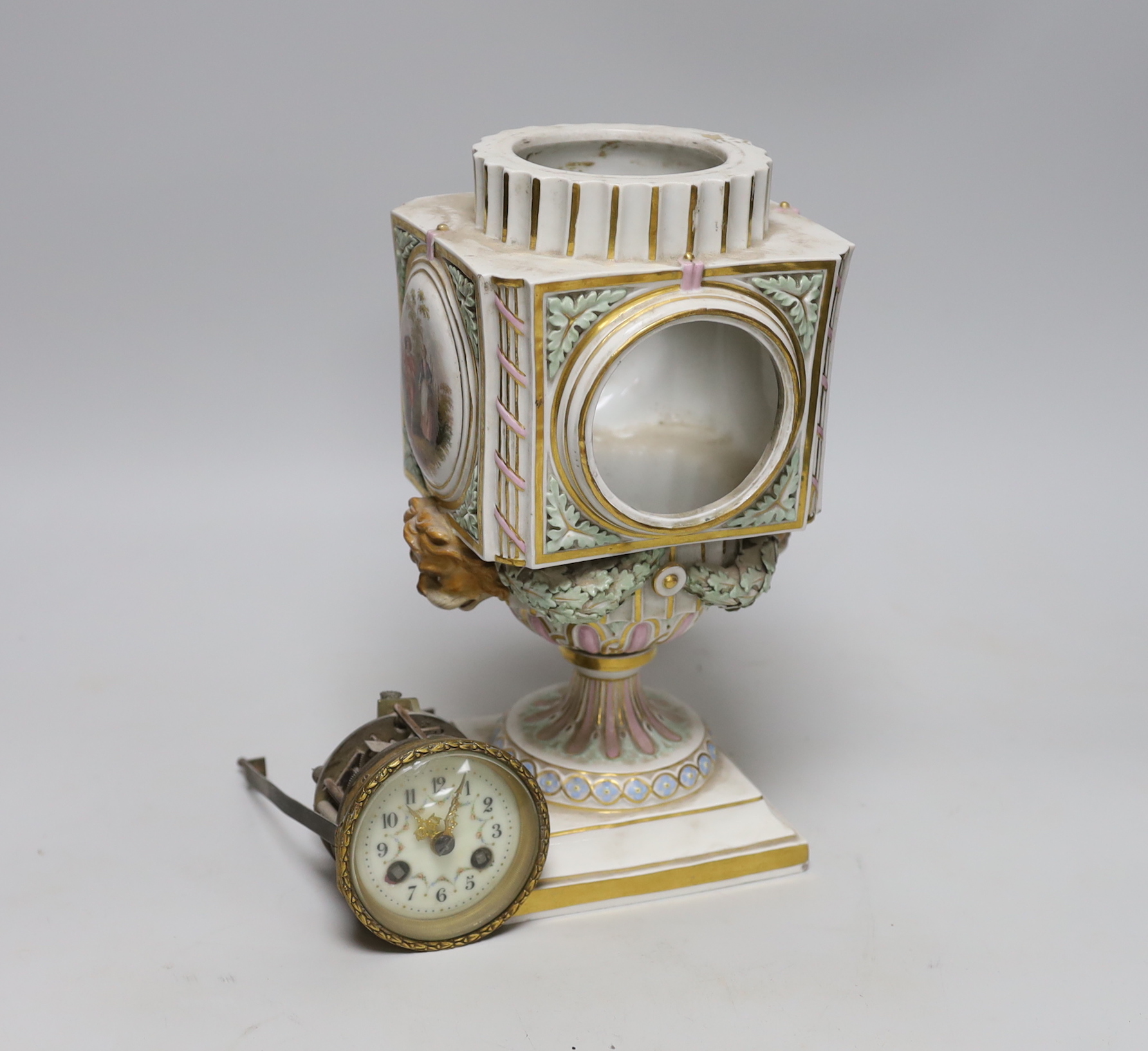 A late 19th century Meissen clock of square form with Watteau scenes and lion mask handles, top missing, 26cm